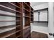 Spacious walk-in closet features custom dark-stained wood shelving at 2544 Thompson Ne Rd, Brookhaven, GA 30319