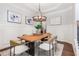 Dining room with modern lighting, wainscoting, and light wood table at 2544 Thompson Ne Rd, Brookhaven, GA 30319