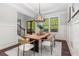 Stylish dining room featuring a wood table, modern chairs, and elegant wainscoting at 2544 Thompson Ne Rd, Brookhaven, GA 30319