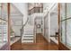 Grand foyer with staircase, hardwood floors, and modern sliding barn door at 2544 Thompson Ne Rd, Brookhaven, GA 30319