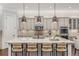 Elegant kitchen boasting a large island with seating, custom cabinets, and modern lighting fixtures at 2544 Thompson Ne Rd, Brookhaven, GA 30319