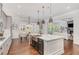 Bright kitchen with a large island, a farmhouse sink, stainless steel appliances, and hardwood floors at 2544 Thompson Ne Rd, Brookhaven, GA 30319
