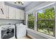 Bright laundry room with large windows and updated appliances, offering both functionality and style at 2544 Thompson Ne Rd, Brookhaven, GA 30319