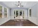 Bright living area with hardwood floors, ceiling fan, and French doors leading to a landscaped yard at 2544 Thompson Ne Rd, Brookhaven, GA 30319