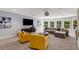 Spacious living room with plush seating and a wall of windows, creating a comfortable and inviting atmosphere at 2544 Thompson Ne Rd, Brookhaven, GA 30319