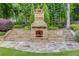 Stunning outdoor fireplace with stone surround and expansive stone patio, perfect for entertaining at 2544 Thompson Ne Rd, Brookhaven, GA 30319