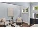 Cozy sitting area features hardwood floors, a cowhide rug, and stylish chairs at 2544 Thompson Ne Rd, Brookhaven, GA 30319