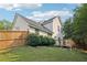 A spacious backyard with a grassy area and a wooden deck on the back of the house at 7033 Brecken Trce, Lithonia, GA 30058