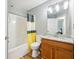Clean bathroom featuring a tub-shower combo, toilet, and granite vanity at 7033 Brecken Trce, Lithonia, GA 30058