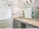 Bathroom with granite countertops, modern lighting, and a glass-enclosed shower at 7033 Brecken Trce, Lithonia, GA 30058