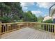 This is a wooden deck with a wooden railing overlooking the lush backyard at 7033 Brecken Trce, Lithonia, GA 30058
