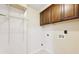 Functional laundry room space with storage cabinets and connections at 7033 Brecken Trce, Lithonia, GA 30058