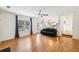 Open-concept living room with hardwood floors, ceiling fan, and a view of the kitchen at 7033 Brecken Trce, Lithonia, GA 30058