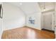 Bright living room featuring hardwood floors, vaulted ceilings, and a large window at 7033 Brecken Trce, Lithonia, GA 30058