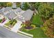 Aerial view displaying the home's well-maintained lawn, garden, and neighborhood street at 8010 Majors Mill Dr, Cumming, GA 30041