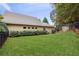Spacious backyard with green lawn, privacy fence, and view of the home's exterior at 8010 Majors Mill Dr, Cumming, GA 30041