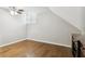 Bedroom with wood floors, shuttered windows, and an angled ceiling at 8010 Majors Mill Dr, Cumming, GA 30041