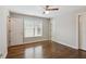 Bedroom with hardwood floors, neutral walls, and a window with blinds at 8010 Majors Mill Dr, Cumming, GA 30041