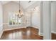 Well-lit dining room with wood floors and a modern chandelier fixture at 8010 Majors Mill Dr, Cumming, GA 30041
