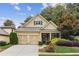 Charming home featuring a two-car garage, manicured landscaping, and a welcoming front porch at 8010 Majors Mill Dr, Cumming, GA 30041