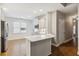 Bright modern kitchen featuring a breakfast bar, stainless steel appliances, and an open floorplan at 8010 Majors Mill Dr, Cumming, GA 30041