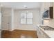 Bright kitchen with white cabinets, modern appliances, and hardwood floors at 8010 Majors Mill Dr, Cumming, GA 30041