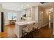 Bright kitchen with white cabinets, stainless appliances, and a breakfast bar at 8010 Majors Mill Dr, Cumming, GA 30041