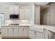 Modern kitchen featuring white cabinets, stone countertops, and stainless steel appliances at 8010 Majors Mill Dr, Cumming, GA 30041