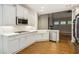Well-lit modern kitchen featuring stainless steel appliances, a breakfast bar, and an open floorplan at 8010 Majors Mill Dr, Cumming, GA 30041