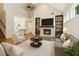 Bright living room featuring vaulted ceilings, built-in bookshelves, and a cozy fireplace at 8010 Majors Mill Dr, Cumming, GA 30041
