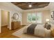 Spacious main bedroom with tray ceiling, a ceiling fan, and large windows at 8010 Majors Mill Dr, Cumming, GA 30041