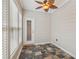 Cozy sunroom featuring tile floor, whitewashed paneling, and ceiling fan at 8010 Majors Mill Dr, Cumming, GA 30041