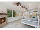 Inviting sunroom with stone fireplace, swing bed, and multiple windows for ample natural light at 8010 Majors Mill Dr, Cumming, GA 30041