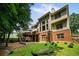 Home's backyard with a multi-level deck, well-maintained lawn, and mature trees at 828 Ivy Ne Cv, Norcross, GA 30071