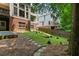 The backyard features a stone path, lush landscaping and a grassy area at 828 Ivy Ne Cv, Norcross, GA 30071