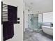 Elegant bathroom featuring a free-standing tub, a glass shower, and a towel warmer at 828 Ivy Ne Cv, Norcross, GA 30071
