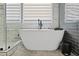 Modern bathroom with a freestanding tub, contemporary fixtures, and sleek tile at 828 Ivy Ne Cv, Norcross, GA 30071