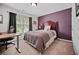 Cozy bedroom with a comfortable bed, desk, and natural light from the window at 828 Ivy Ne Cv, Norcross, GA 30071