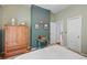 Bright bedroom featuring high ceilings, a dresser, and neutral decor at 828 Ivy Ne Cv, Norcross, GA 30071