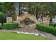 Stone sign for the Bishops Glen community established in 2000, surrounded by green landscaping at 828 Ivy Ne Cv, Norcross, GA 30071