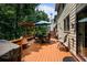 Spacious deck with outdoor seating, grill, and views of the surrounding lush greenery at 828 Ivy Ne Cv, Norcross, GA 30071