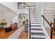 Grand foyer with hardwood floors, elegant staircase, and open floor plan at 828 Ivy Ne Cv, Norcross, GA 30071