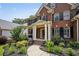 Close up of the brick home featuring a front porch with columns and landscaped front yard at 828 Ivy Ne Cv, Norcross, GA 30071