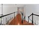 Bright hallway with hardwood floors and white wainscoting exudes a welcoming and airy ambiance at 828 Ivy Ne Cv, Norcross, GA 30071