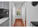 Hallway with wooden floors, white barn doors, and gray accent wall at 828 Ivy Ne Cv, Norcross, GA 30071