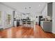 Kitchen area has wood floors, island with seating, stainless appliances and stylish cabinets at 828 Ivy Ne Cv, Norcross, GA 30071