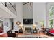Bright living room features high ceilings, a fireplace, and a large window for natural light at 828 Ivy Ne Cv, Norcross, GA 30071