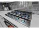 Close-up of a modern stovetop with a stylish tile backsplash and countertop at 828 Ivy Ne Cv, Norcross, GA 30071