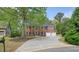 Inviting two-story red brick home featuring a two-car garage and a long driveway at 3130 Crestmont Nw Way, Kennesaw, GA 30152
