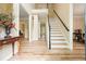 Bright foyer with hardwood floors and a staircase leading to the second floor at 3130 Crestmont Nw Way, Kennesaw, GA 30152